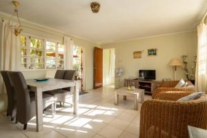 a living room with a table and chairs at The Dive Hut - Boutique Apartments in Kralendijk