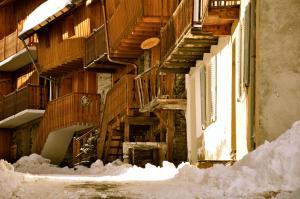 a building with snow on the ground in front of it at Two Bedroom Apartment La Voute, Chandon near Meribel - Sleeps 4 Adults or 2 Adults and 3 Children in Les Allues