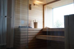 a bathroom with a glass shower with a window at Hotel Gabriella in Fanano
