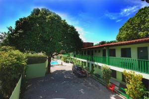 a car parked in a parking lot next to a building at Pousada Tapuia in Porto Seguro