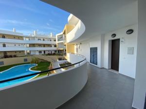 a view from the balcony of a building with a swimming pool at Albur Village B - Lotus in Alvor