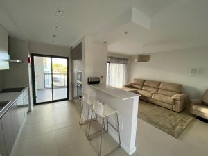 a kitchen and living room with a counter and a couch at Albur Village B - Lotus in Alvor
