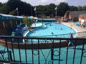 a large swimming pool with people in it at Isle of Wight Caravan in Shanklin