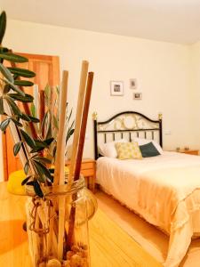 a bedroom with a bed and a vase with a plant at Valley Views Full House Stargazing in Valencia in Ayora