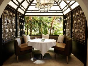 a dining room with a table and chairs and a window at Hotel Bel-Air - Dorchester Collection in Los Angeles