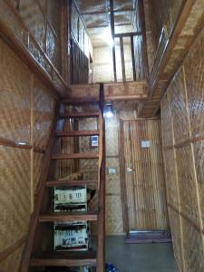 an inside view of a room with wooden stairs at Calayo Beach Resort in Nasugbu