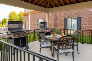 a patio with a grill and a table and chairs at Candlewood Suites Cookeville by IHG in Cookeville
