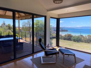 a living room with a view of the ocean at Convict Beach Coastal Retreat in Saltwater River