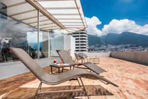 a patio with two chairs and a table on a balcony at Holiday Inn Express Quito, an IHG Hotel in Quito