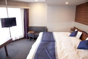 Postel nebo postele na pokoji v ubytování Hotel Il Credo Gifu