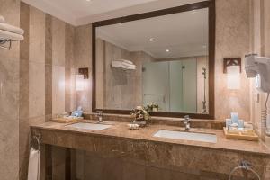 a bathroom with a sink and a mirror at Henann Resort Alona Beach in Panglao