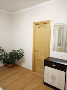 a room with a door and a potted plant at Guest House Lukomorye in Anapa