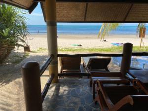 a view of a beach with chairs and the ocean at Laguna Beach Club Resort in Ko Lanta
