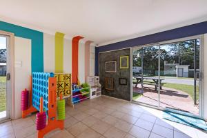 a colorful room with a sliding glass door at Discovery Parks - Forster in Tuncurry
