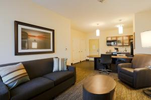 a living room with a couch and a table at Candlewood Suites Auburn, an IHG Hotel in Auburn