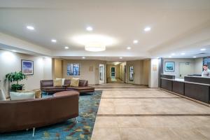 a lobby of a hospital with couches and a counter at Candlewood Suites Auburn, an IHG Hotel in Auburn