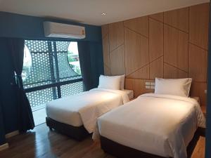 Ένα ή περισσότερα κρεβάτια σε δωμάτιο στο Hotel Fuse Rayong