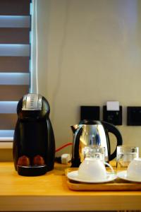 a coffee maker and a tea kettle on a table at Mayfair Resort in Panglao Island