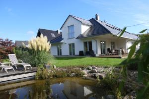 a house with a pond in front of it at Ruhepol in Travemünde