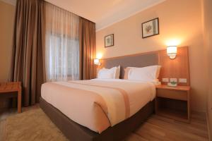 Postel nebo postele na pokoji v ubytování Mado Hotel