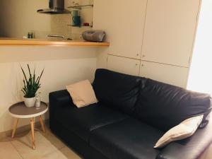 
a white couch sitting on top of a wooden table at Deluxe Apartment with Shared Pool in Ostend
