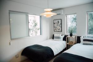 Postel nebo postele na pokoji v ubytování villa okinawa onna