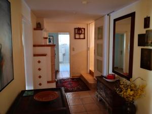 a hallway of a home with a kitchen and a mirror at Holiday Apartment Krumpendorf in Krumpendorf am Wörthersee