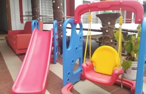 a playground with a slide in a living room at Ooty Dormitories in Ooty