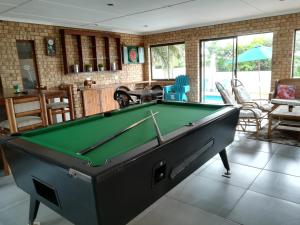 a pool table in a living room with a pool table at Rockview Guest House in Port Edward