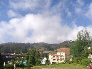 a town on a hill with a building on it at Ooty Dormitories in Ooty