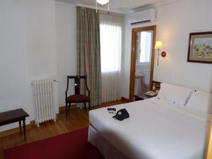 Postel nebo postele na pokoji v ubytování Hostal Navarra
