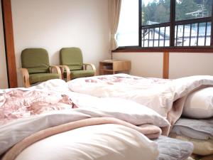 Postel nebo postele na pokoji v ubytování Guest House hachi hachi