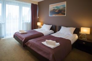 Łóżko lub łóżka w pokoju w obiekcie Hotel Avangarda