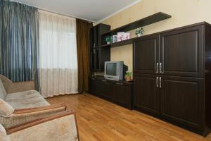 a living room with black cabinets and a television at 2 room in Centre on Troitskaya 3 floor in Sumy