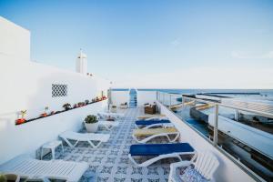 a balcony with chairs and the ocean in the background at Hotel Miramar in Arrecife