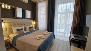 Postel nebo postele na pokoji v ubytování ANTARES Apart hotel
