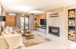 a living room with a couch and a fireplace at Gruszowa Villa in Kalwaria Pacławska