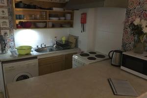 a kitchen with a sink and a stove top oven at Cathedral apartment in Derry Londonderry