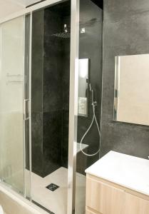 y baño con ducha y puerta de cristal. en Apart 2 Opera New 2-3 Rooms for 4 guests en París