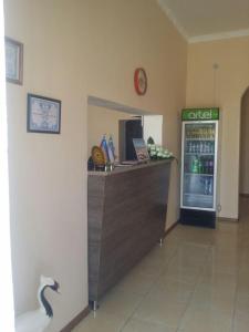 a restaurant with a counter with a drink cooler at RATMINA Muinak in Mŭynoq