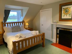 a bedroom with a bed with towels on it at The Cottage Aberlour in Aberlour