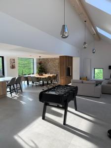 a living room with a couch and a table at La cachette dans le verger in Foy-Notre-Dame
