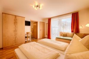 pokój hotelowy z dwoma łóżkami i stołem w obiekcie Appartementhaus Berger w mieście Grossarl