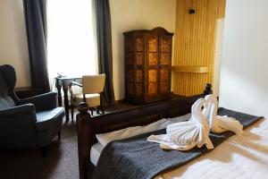 a hotel room with two swans on a bed at Hotel U Kříže in Prague