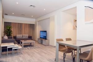 a living room with a couch and a tv at salmiya - Amman -Family only in Kuwait
