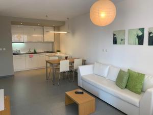 a living room with a white couch and a table at View Apartments in Sozopol