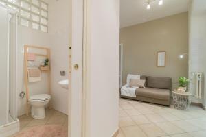 a bathroom with a toilet a sink and a couch at Vaticano San Pietro Apartment in Rome +18 photos