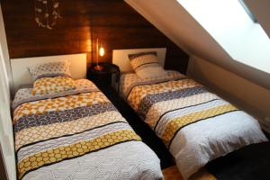 a room with two beds in a attic at Appartement atypique au coeur de Gap in Gap +2 photos