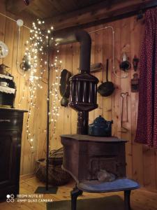 a room with an old fashioned stove with christmas lights at Appartamento Lo Bou in Valsavarenche