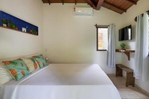 Cama ou camas em um quarto em Pousada Jakuara